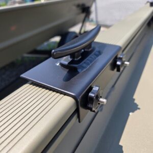 Boat cleat on a metal rail outdoors.