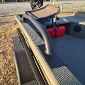 Boat deck with railing and motor.