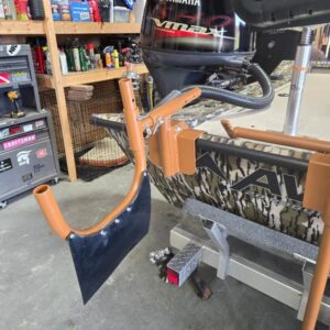Boat motor with propeller in garage.