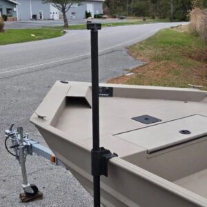 Boat on trailer near a rural road.