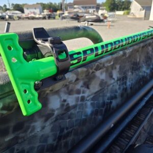Green fishing rod holder on vehicle rack.