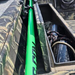 Green rod in camo-patterned boat storage.