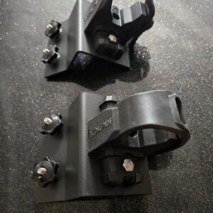 Black metal clamps on reflective surface.