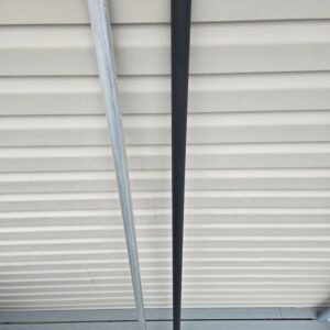 Two swords leaning against a wall.