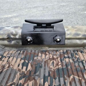 Boat cleat on camo-patterned surface.